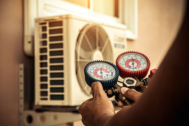Professional Air Conditioning Service technician working in Baldwin Place, NY